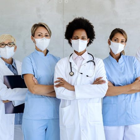 Healthcare workers standing in a medical facility with masks.