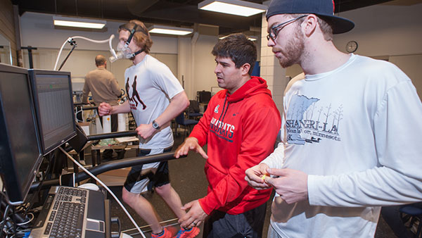 St. Scholastica students monitoring a student running in an exercise physiology lab.