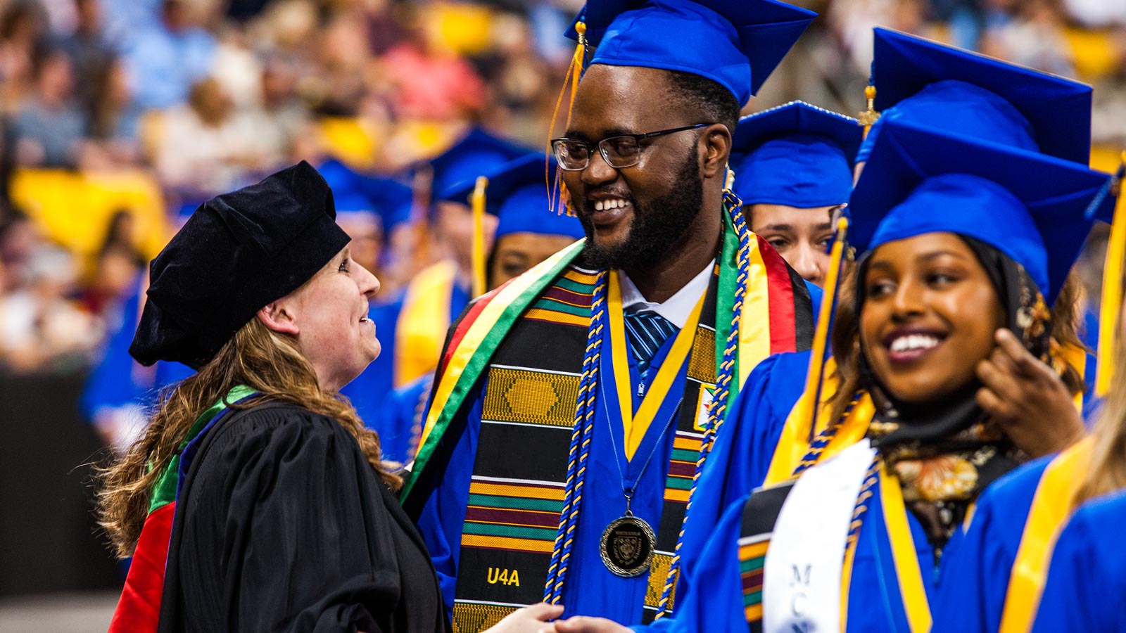 Student greeted by a faculty member at Commencement
