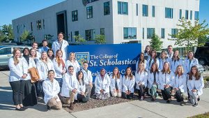 St. Scholastica PA Medicine graduates group photo in front of the Health Science Center in Duluth, MN.